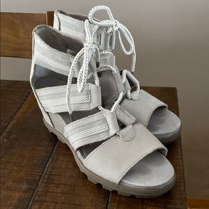 Cream wedge sandals with multiple straps and adjustable laces